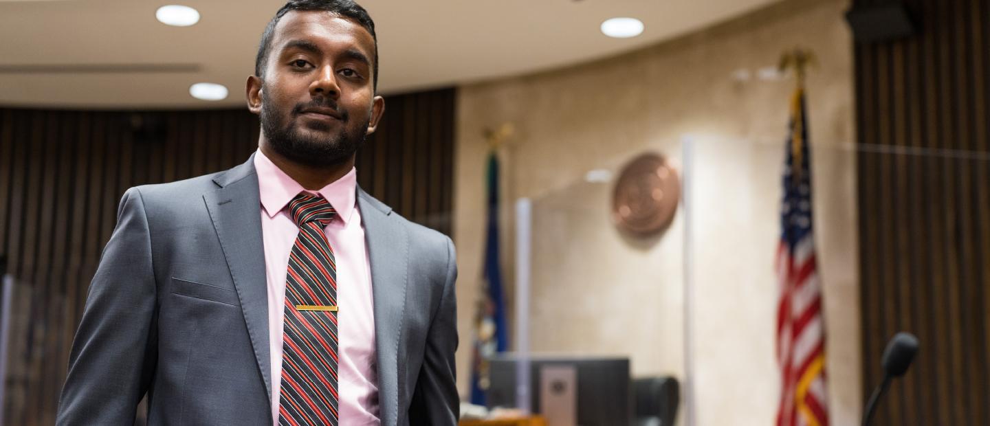 Man in suit standing in courtroom